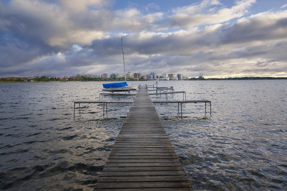 Photo of a dock with the Madison skyline in the background.