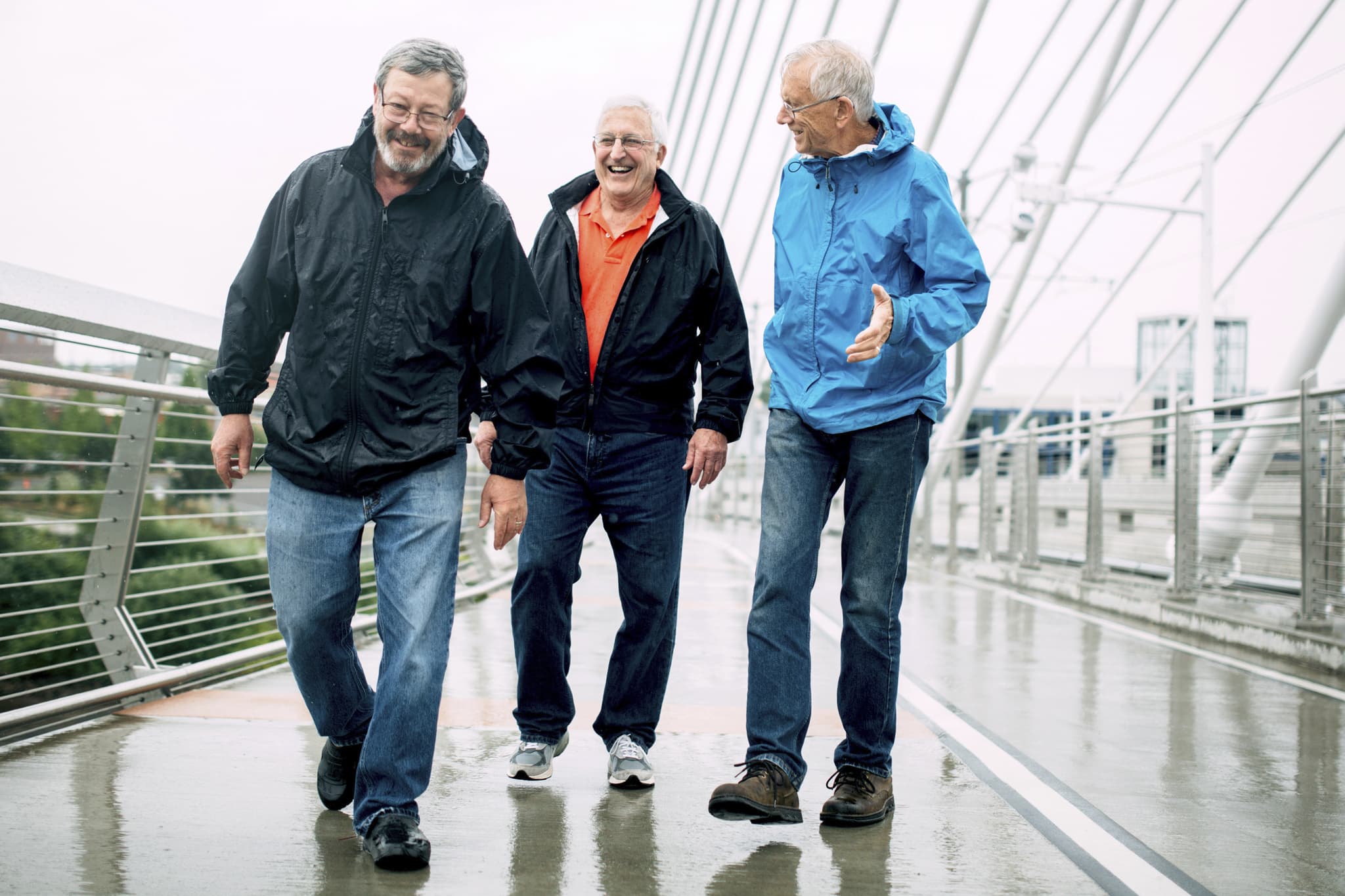 Three guys walking and enjoying each other's company.